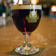 Beer glass full of dark amber Grimbergen beer